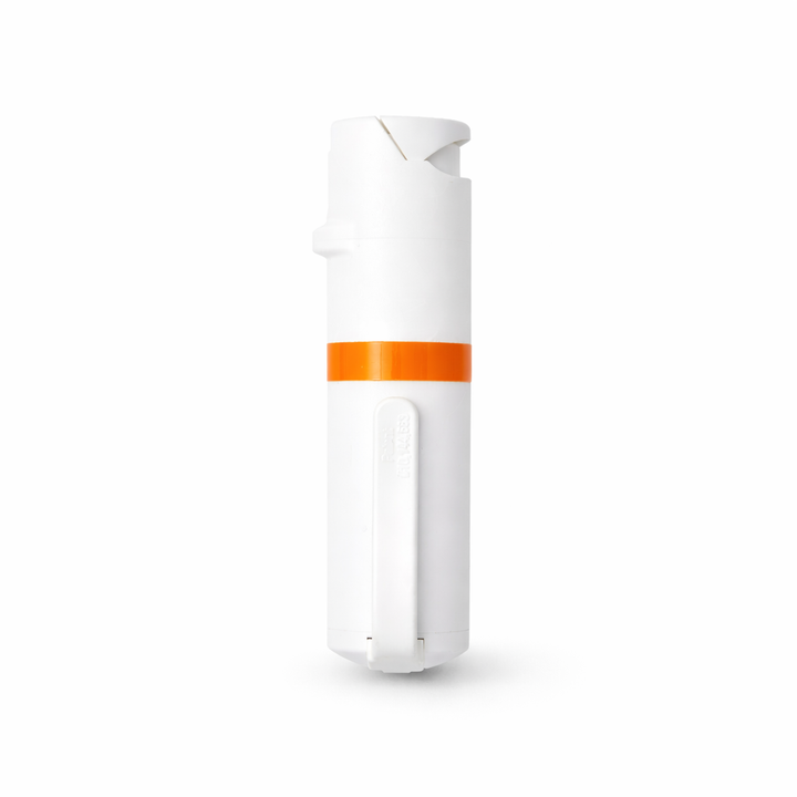 White and orange pepper spray bottle on a white background